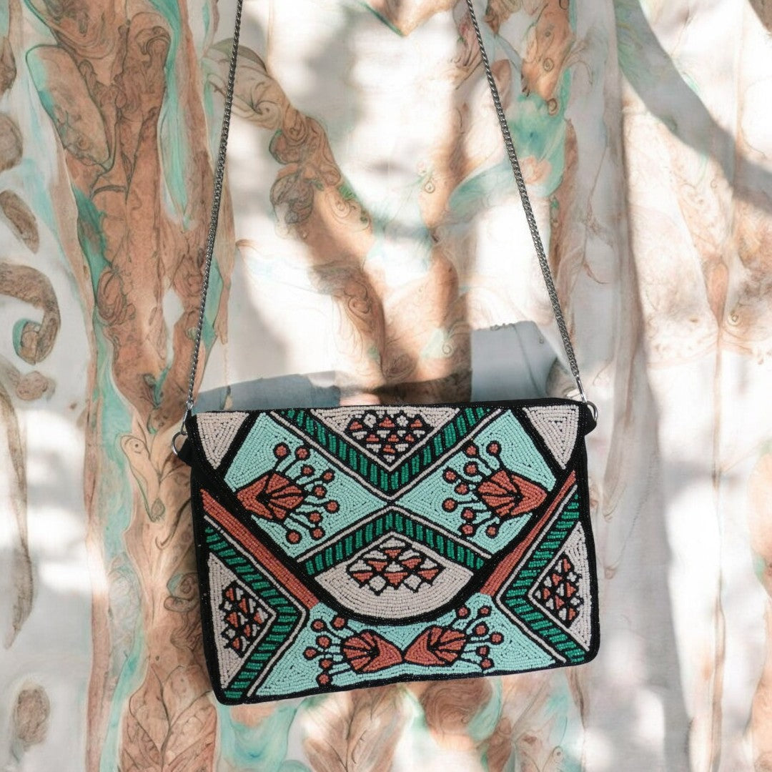 Beaded clutch bag with green, coral, turquoise and black beading, with a detachable cross body chain