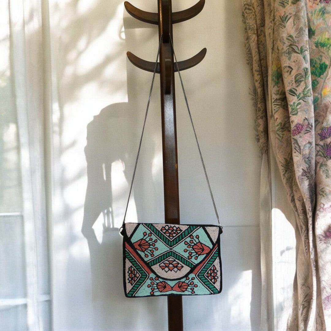 Beaded clutch bag with green, coral, turquoise and black beading, with a detachable cross body chain