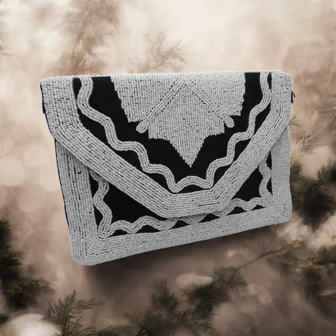 Black clutch bag with white beading with a detachable cross body chain