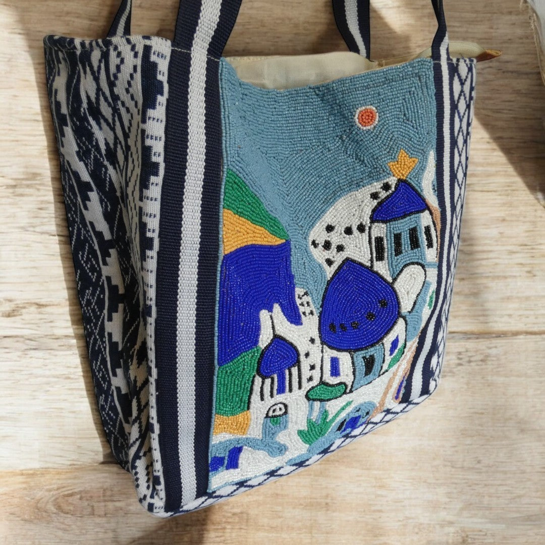 Santorini Style Beaded Bag In Blue, White, Yellow And Green With Striped Detail on the straps and a tribal pattern around the outside in blue and white