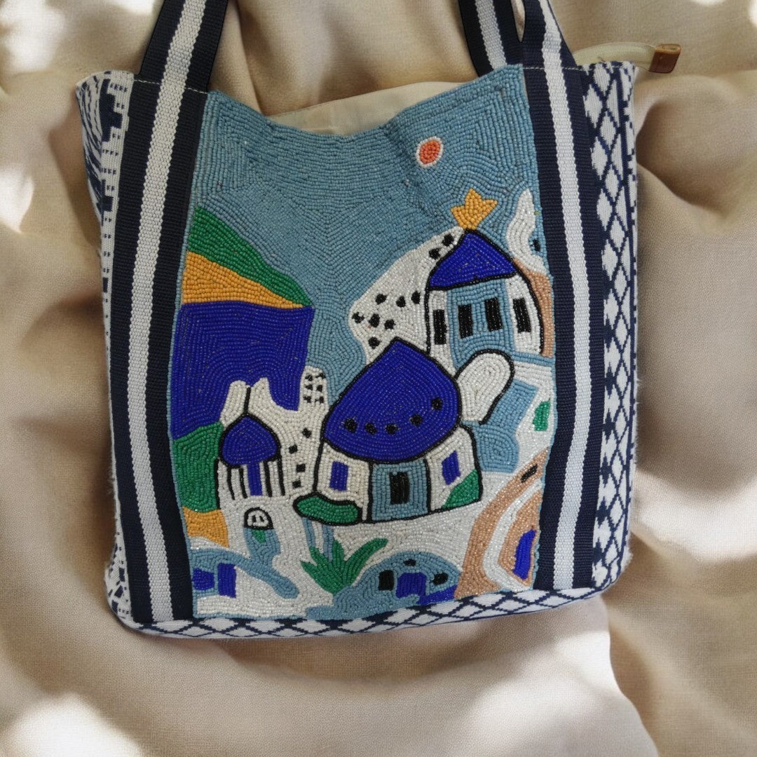 Santorini Style Beaded Bag In Blue, White, Yellow And Green With Striped Detail on the straps and a tribal pattern around the outside in blue and white