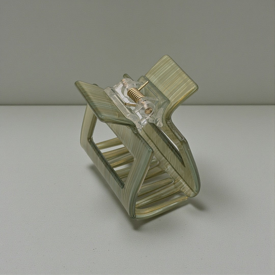 A small hair claw clip in green