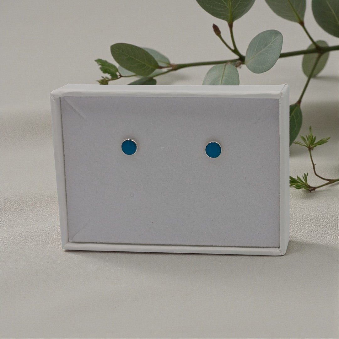 A dainty pair of round turquoise stud earrings in sterling silver