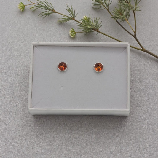 A pair of round sterling silver amber stud earrings