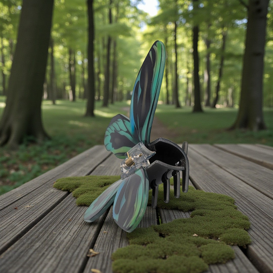 A butterfly hair claw clip in black, blue and green