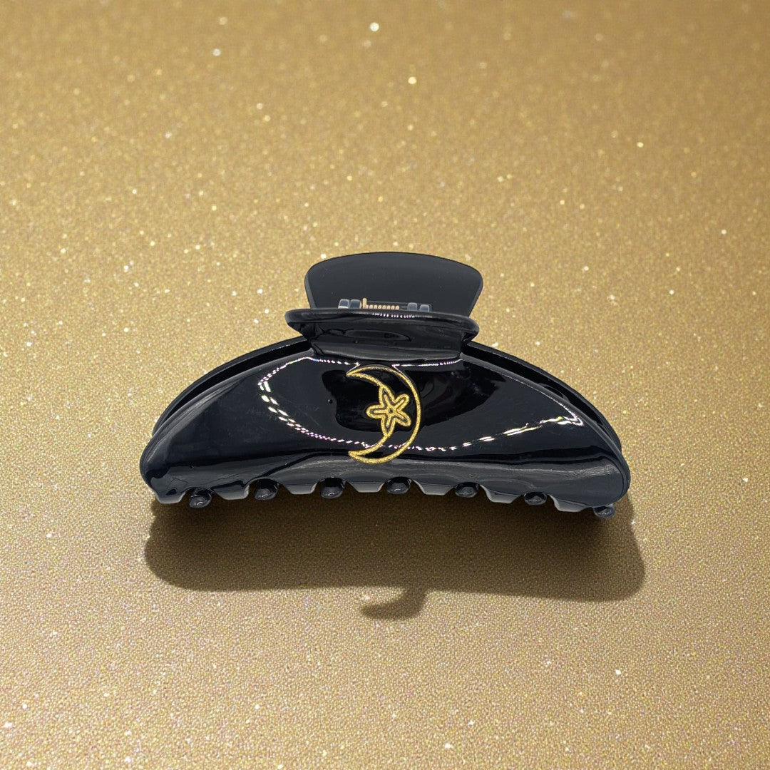 Black claw clip with gold moon and star