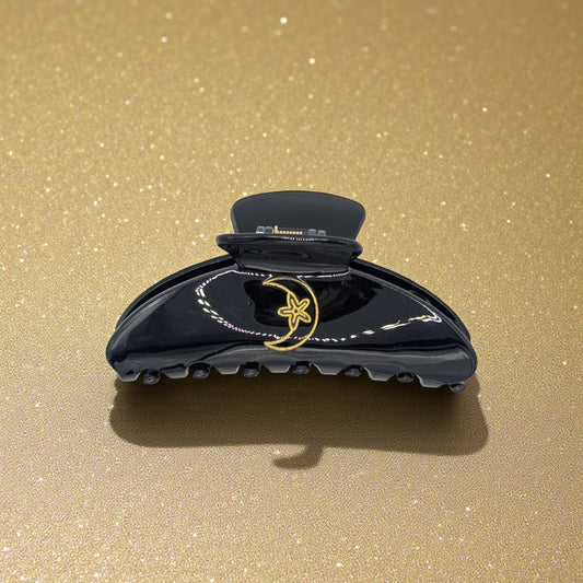 Black claw clip with gold moon and star