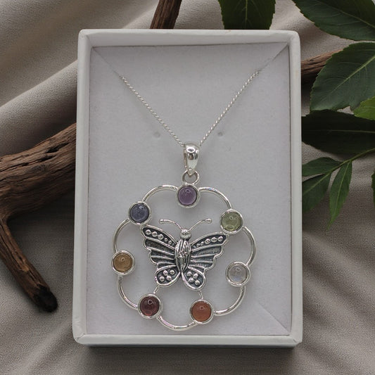 A butterfly necklace with chakra gemstones on an 18 inch chain