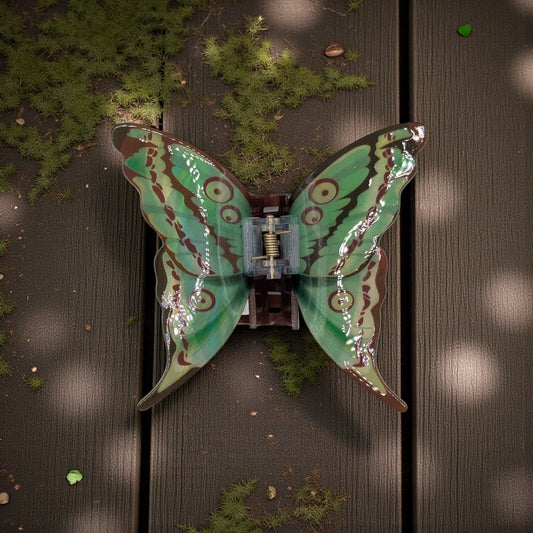 A luna moth hair claw clip in green and brown