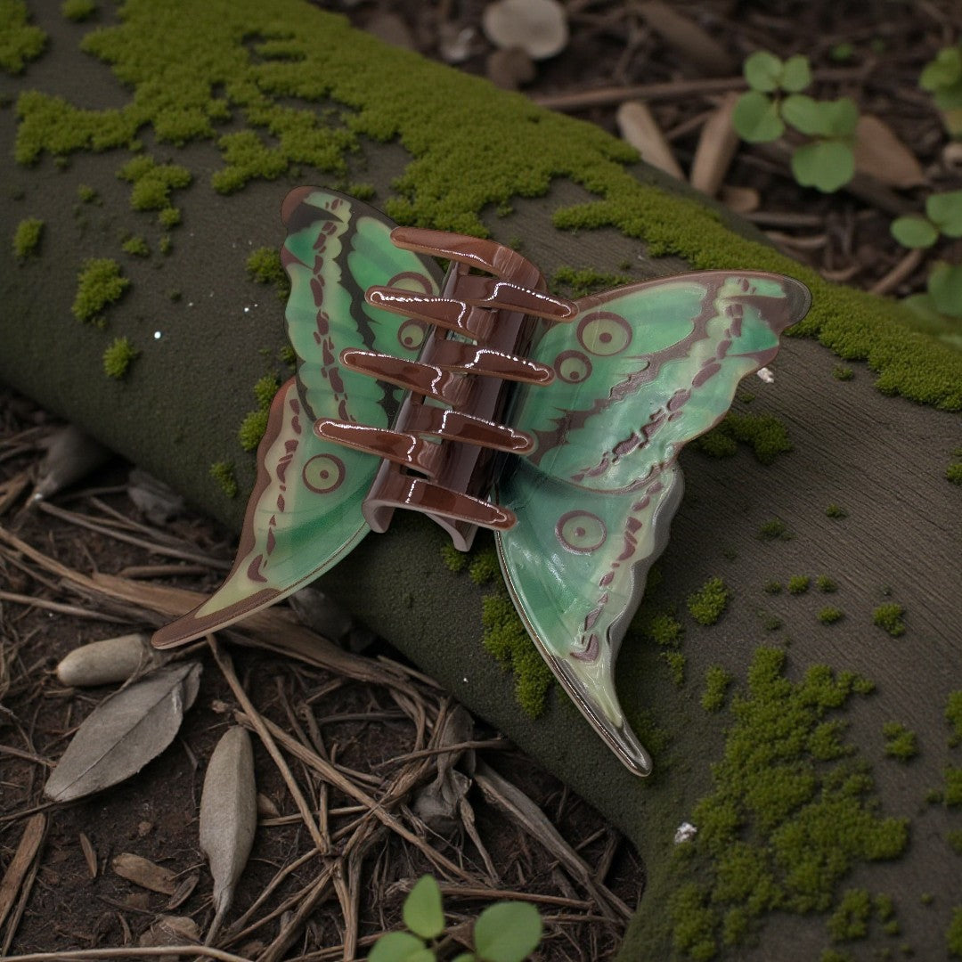 A luna moth hair claw clip in green and brown
