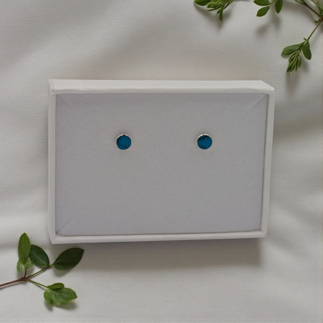 A dainty pair of sterling silver turquoise stud earrings